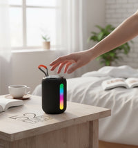 Swiss Military Audio WIGGLY 5W Bluetooth speaker with dynamic RGB lighting and 52mm driver, black fabric finish, portable with carry strap.
