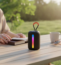 Swiss Military Audio WIGGLY 5W Bluetooth speaker with dynamic RGB lighting and orange carry loop.